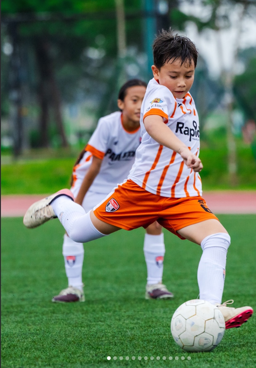 Young footballers playing together on the pitch